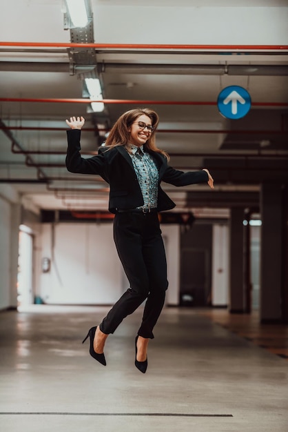 Photo a successful business woman celebrates her job by jumping into the air