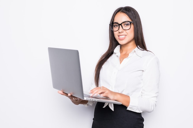 Successful business woman is standing with laptop on isolated.