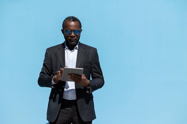 Successful businessman Elegant darkskinned man with a laptop in hands