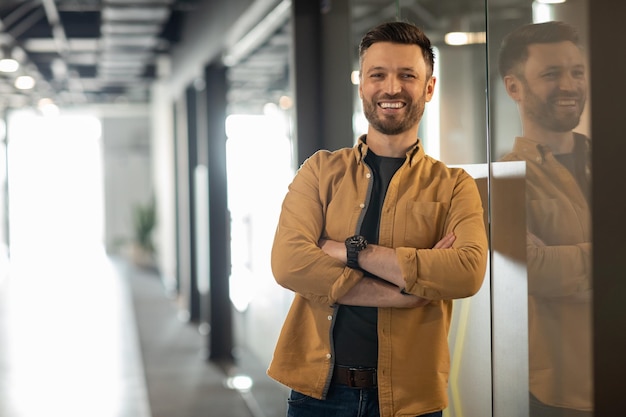 Successful Businessman Posing Standing In Doorway In Office