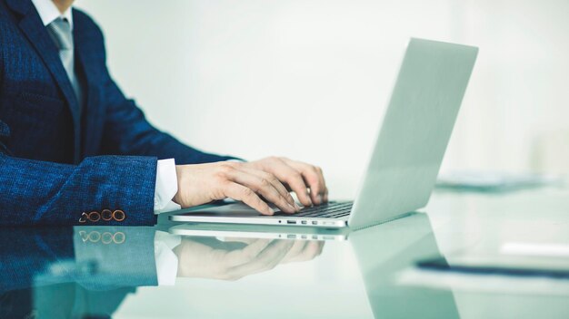 Successful businessman working on laptop in the workplace