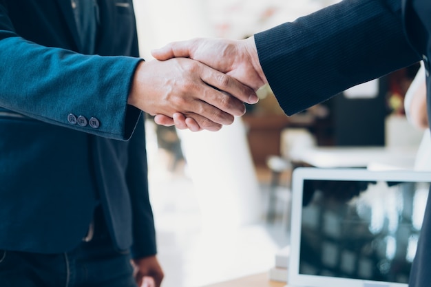 Successful businessmen handshaking after good deal.