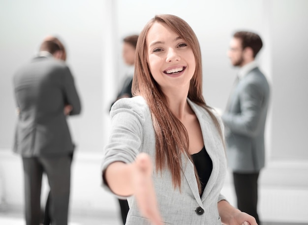 Successful businesswoman holding out her hand for a handshakeconcept of partnership