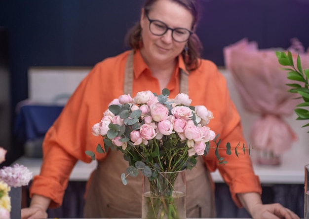 Successful and creative female entrepreneur and owner of the flower shop wearing apron