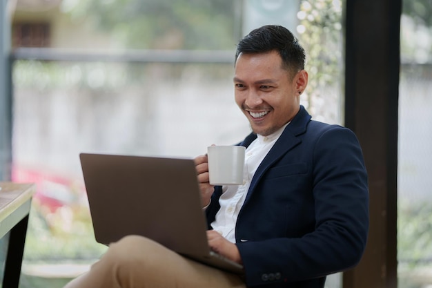 A successful entrepreneur analyzing a technical price graph and indicator with laptop computer