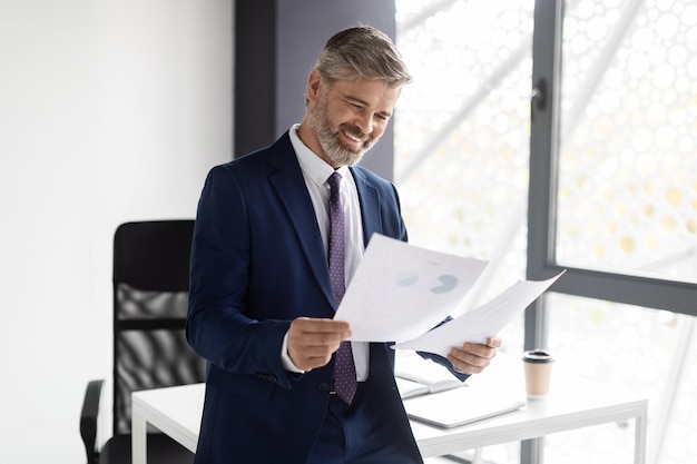 Successful Entrepreneurship Concept Happy Mature Businessman In Suit Checking Financial Papers