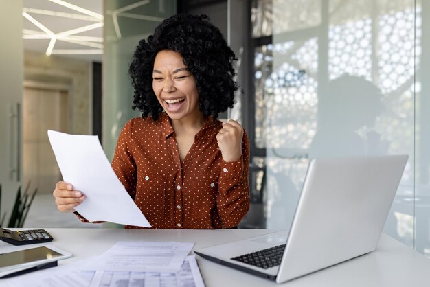 Successful financier woman satisfied with results checking report businesswoman at workplace happy