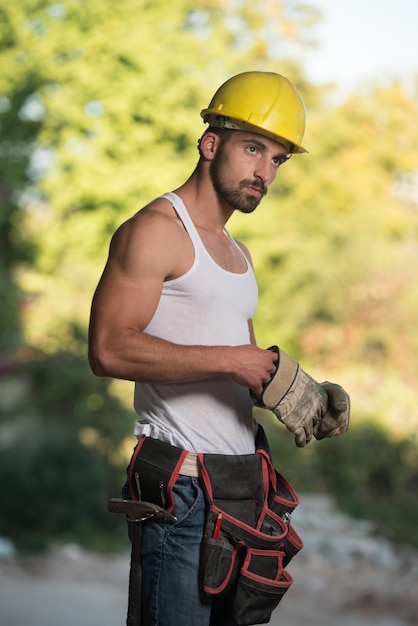 Successful Male Architect At A Building Site With Gloves Takes Off