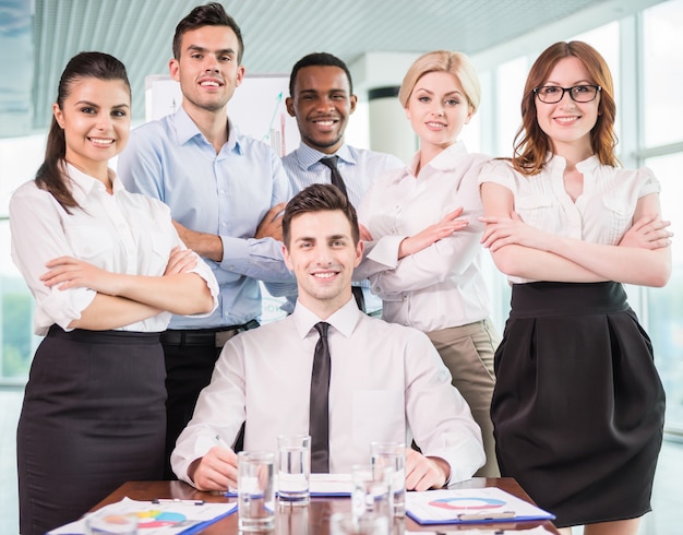 Successful team leader with his team at meeting room.