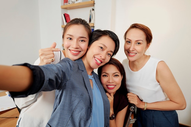 Successful team taking group selfie