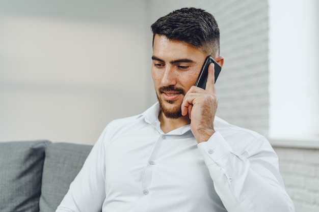 Successful young businessman talking on his cellphone