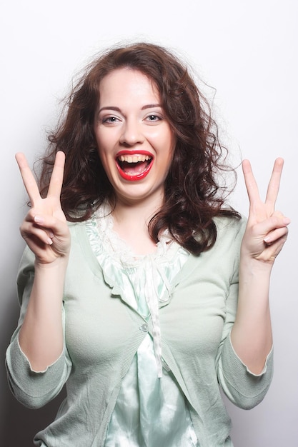 Successful young girl gives thumb up with two hands