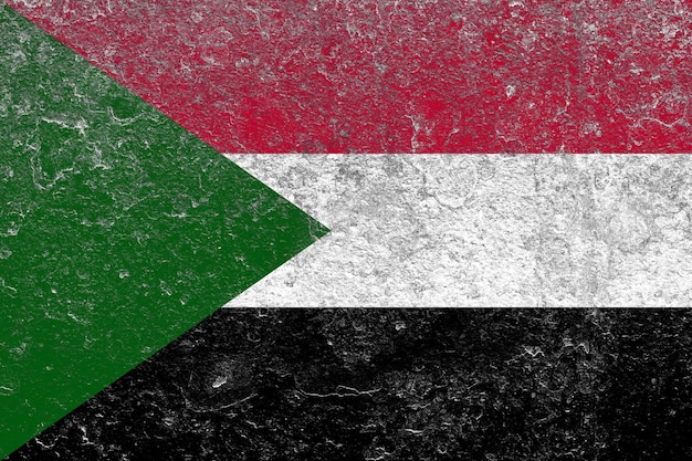 Sudan flag painted on a damaged old concrete wall surface