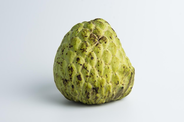 sugar apple ( srikaya ) with black spots, isolated on a white background