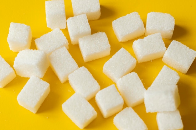 Sugar cube on yellow background isolated design mockup b