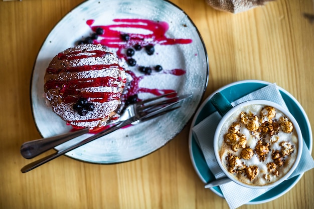 Sugar dessert pan cakes with berries and jam Breakfast concept