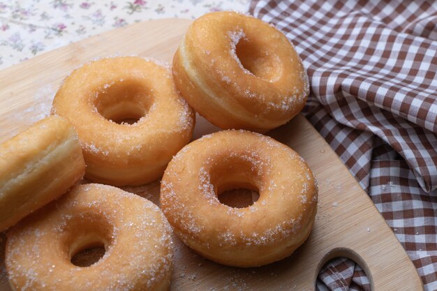 Sugar donuts on wooden board