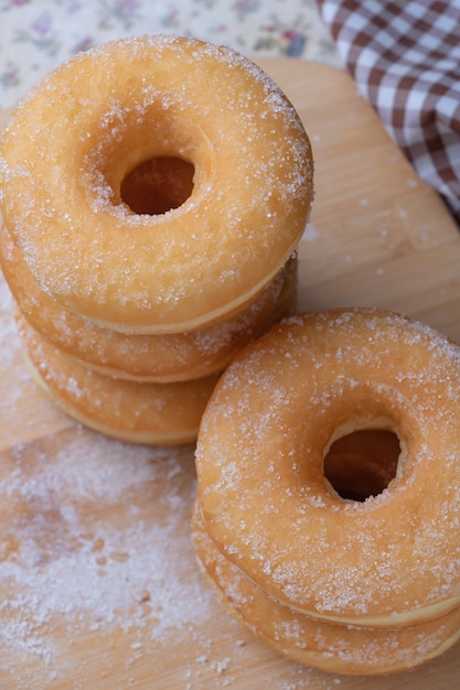 Sugar donuts on wooden board