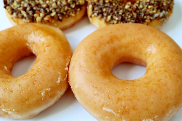 Sugar glazed donuts with blurry another glazed donuts in background