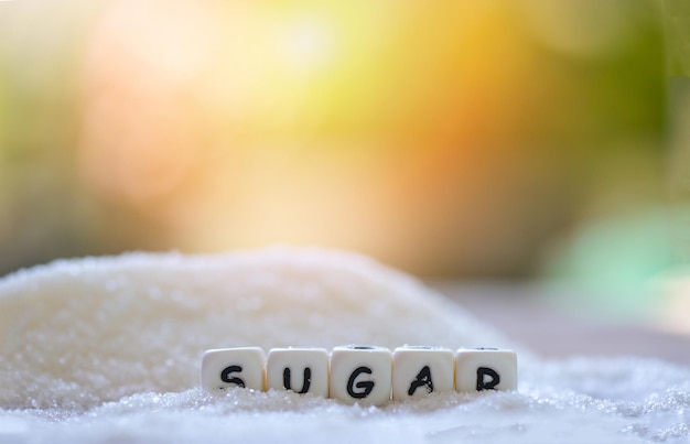 Sugar on nature blur background white sugar for food and sweets dessert candy heap of sweet sugar crystalline granulated