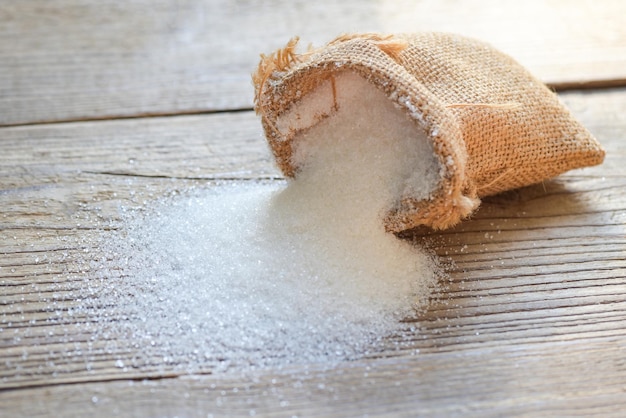 Sugar sack on wooden background white sugar for food and sweets dessert candy heap of sweet sugar crystalline granulated