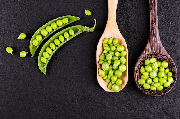 Sugar snap peas with mint on a rustic wood background