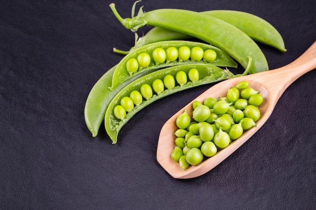 Sugar snap peas with mint on a rustic wood background