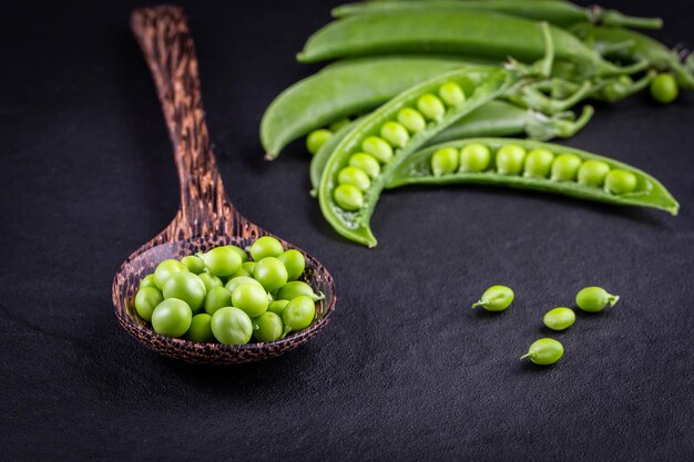 Sugar snap peas with mint on a rustic wood background