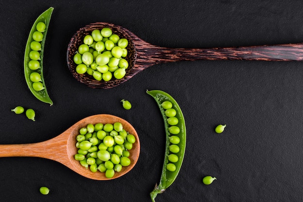 Sugar snap peas with mint on a rustic wood spoon