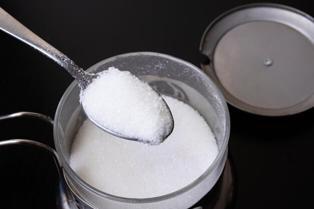 Sugar in a spoon by the can