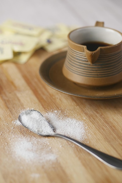 Sugar Substitute sweetener and tea cup on table