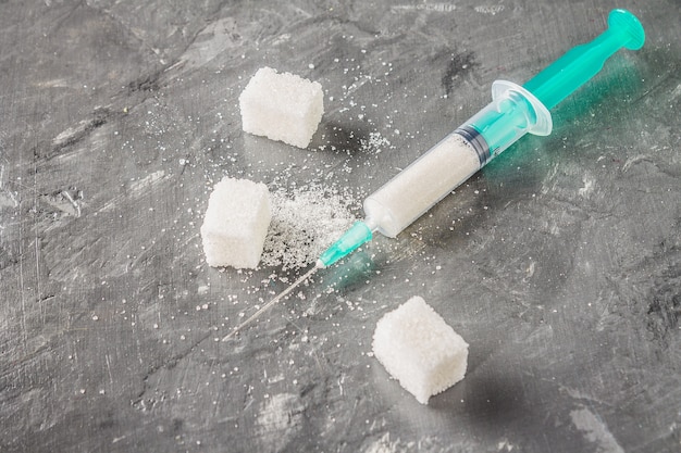 Sugar in a syringe. Conceptual depiction of dependence on the sweet. Sugar is a drug.