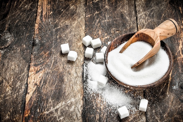 Sugar with a scoop in a bowl.