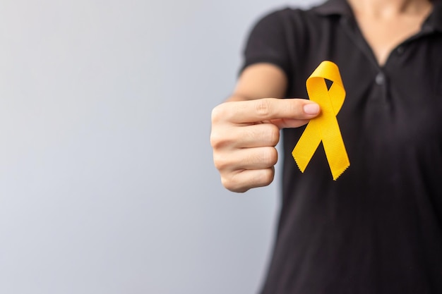 Suicide prevention day Childhood Sarcoma bone and bladder cancer Awareness month Yellow Ribbon for supporting people life and illness children Healthcare and World cancer day concept