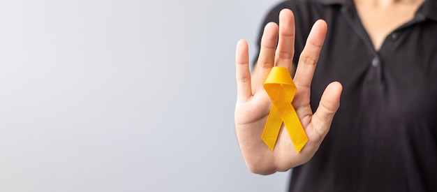 Suicide prevention day Childhood Sarcoma bone and bladder cancer Awareness month Yellow Ribbon for supporting people life and illness children Healthcare and World cancer day concept