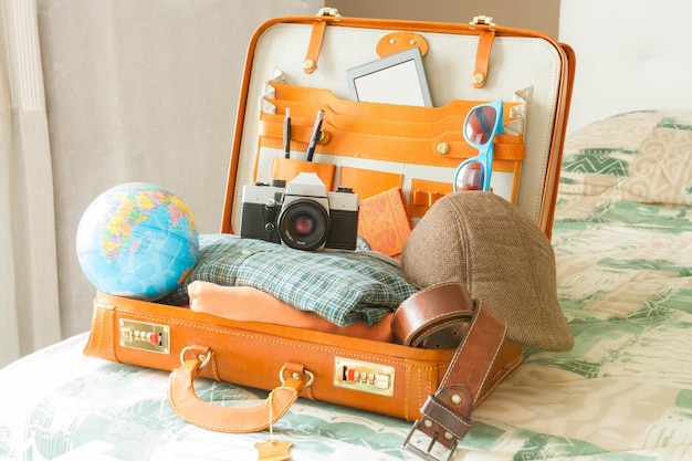 Photo suitcase full of items for travel. illusion, hope, joy and new destinations.