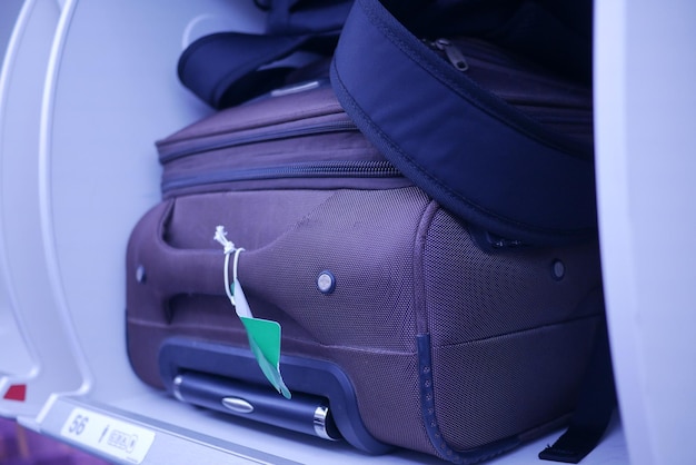 Suitcase in a overhead baggage area in a airplane cabin