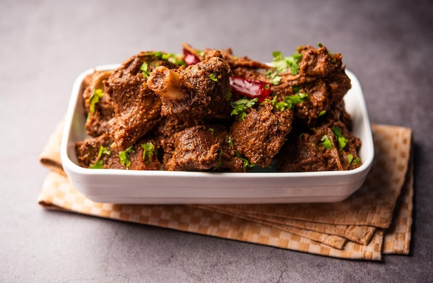 Sukha mutton or chicken dry spicy Murgh or goat meat served in a plate or bowl