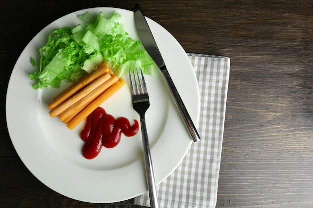 Suluguni cheese with sauce and salad on table close up