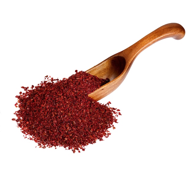 Sumac in the wooden spoon isolated on white background High resolution photo