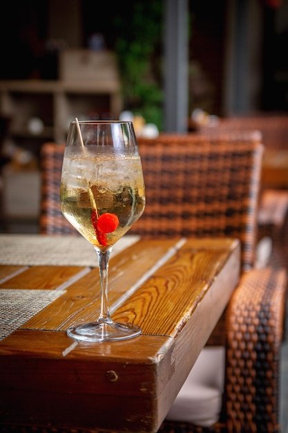 Summer alcoholic cocktail Aperol lillet spritz with cherry a beach refreshing cocktail at the bar