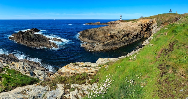 Summer Atlantic ocean coastline landscape (island Pancha with lighthouse), Spain. Two shots stitch panorama.