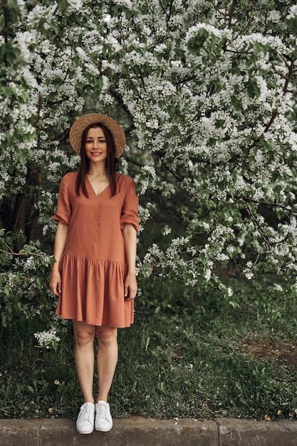 Summer background. Beautiful young girl in blooming shits