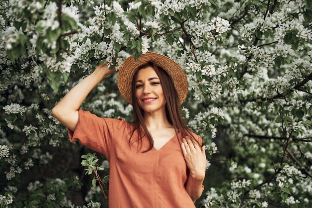 Summer background. Beautiful young girl in blooming shits