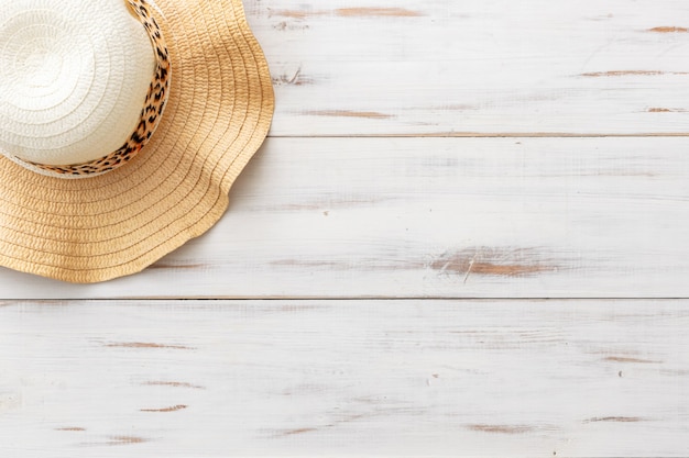 Summer background concept straw hat on light wooden surface