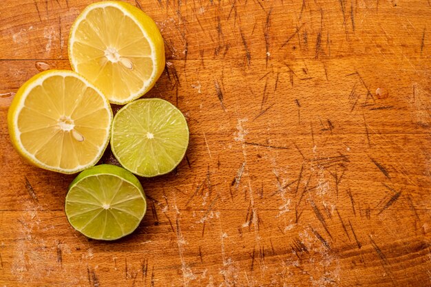 Summer background of cut lemon and orange on wooden surface