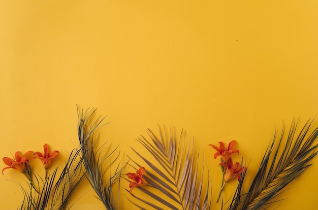 Summer background palm leaves and flowers