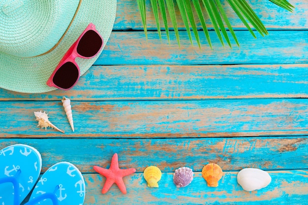 Summer background - Straw hat, sunglasses, slipper, starfish and shells