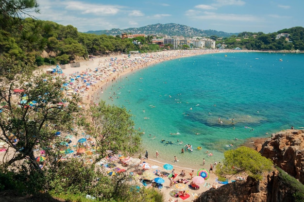 Summer beach full of people Costa Brava