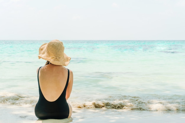 Summer Beach Holiday Woman relax on the beach in free time .